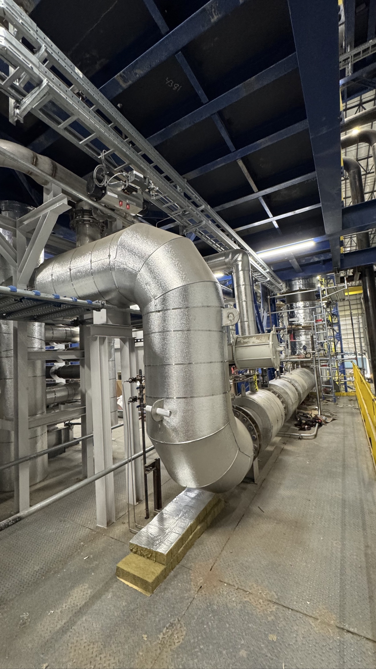 Finished metal jacketing protecting industrial insulation
